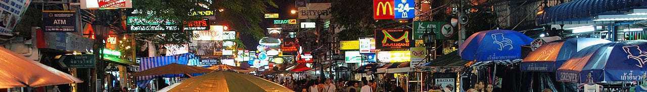 Khao San Road at night — neon signs, street vendors, and crowds